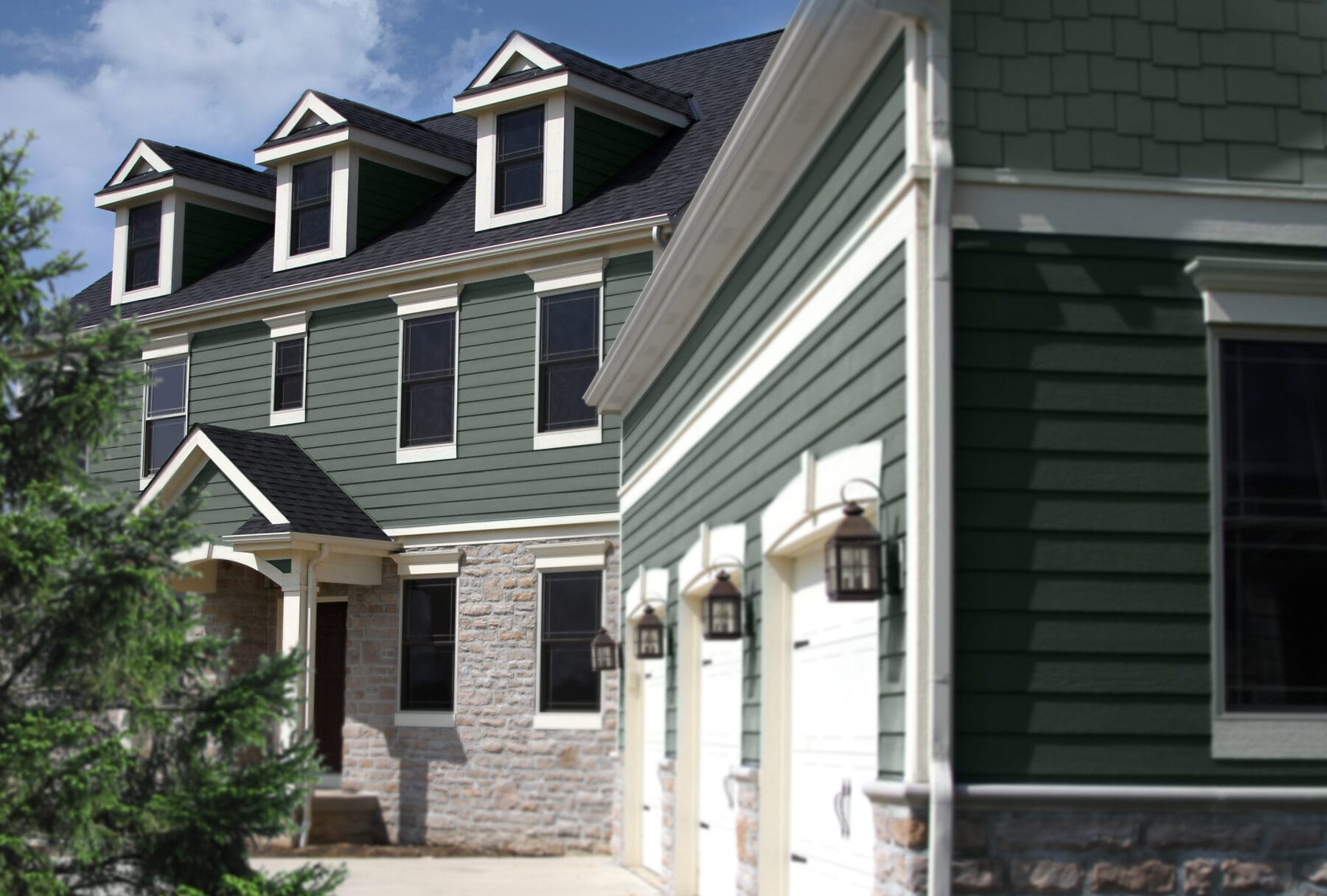 Home with green CedarMAX vinyl siding with three garages.