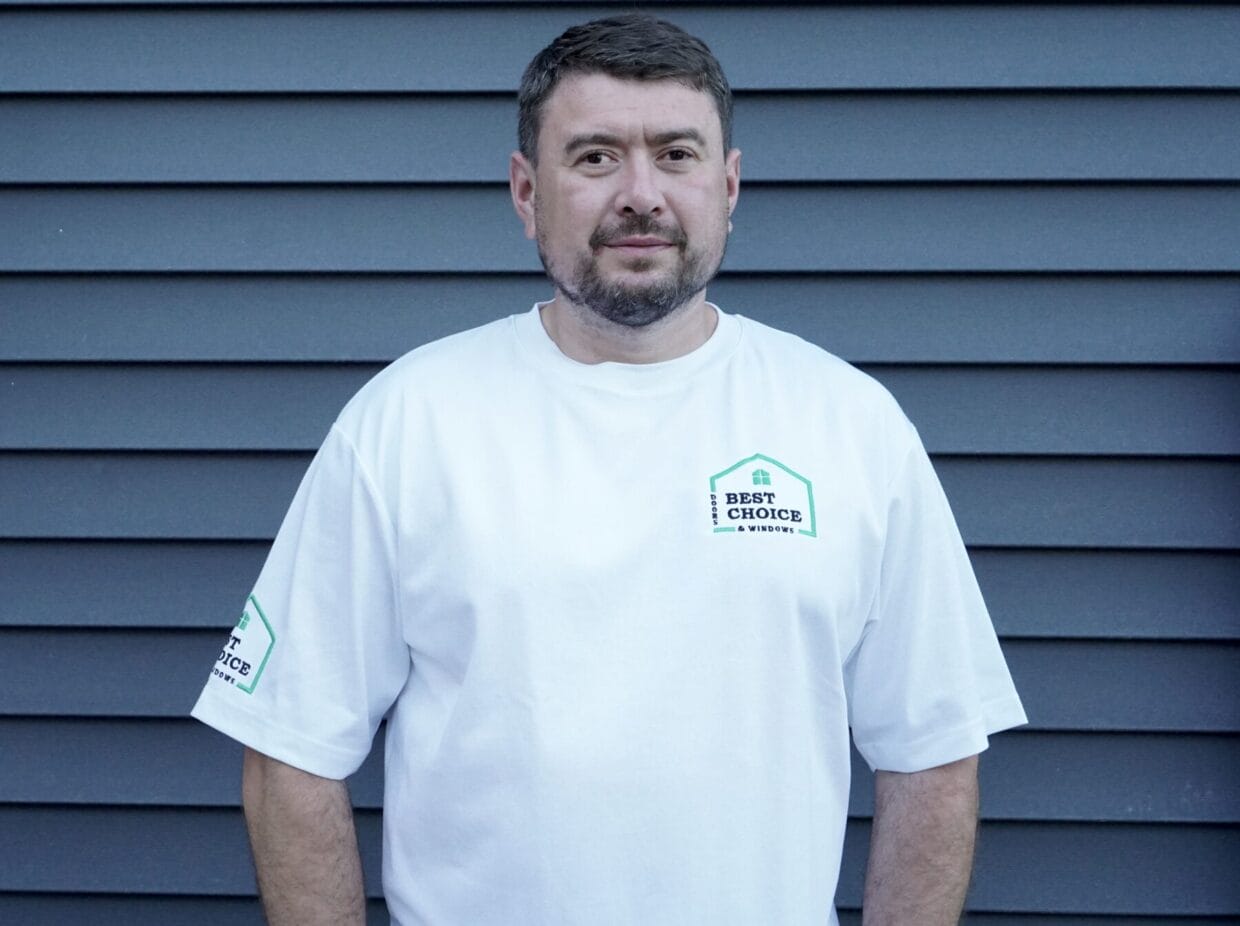 Headshot of Max wearing a company shirt.