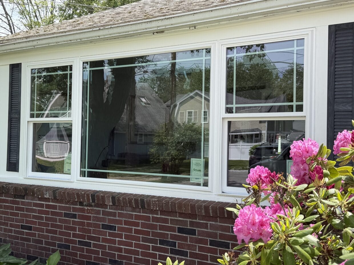 Newly installed ProVia triple mulled vinyl window with colonial-style grids and custom exterior trim on a Rye, New Hampshire home, enhancing energy efficiency, natural light, and curb appeal.